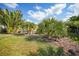 Spacious back yard features lots of lush tropical landscaping and shade trees at 621 Tarpon Way, Punta Gorda, FL 33950