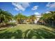 Back yard has lots of lush tropical landscaping plus a grassy area at 621 Tarpon Way, Punta Gorda, FL 33950