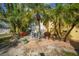 Landscaped backyard with patio, palm trees, and stone pathway at 621 Tarpon Way, Punta Gorda, FL 33950