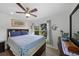 Inviting bedroom featuring a ceiling fan and window looking out to lush greenery at 621 Tarpon Way, Punta Gorda, FL 33950