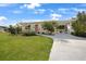 Inviting home with lush landscaping, a well-kept lawn, and a covered carport, presenting a perfect blend of comfort at 621 Tarpon Way, Punta Gorda, FL 33950