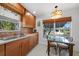 Cozy kitchen featuring wood cabinets, a stainless steel sink and tile backsplash at 621 Tarpon Way, Punta Gorda, FL 33950