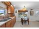 Eat-in kitchen features wood cabinets, a window and adjacent dining set at 621 Tarpon Way, Punta Gorda, FL 33950