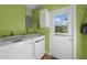 Functional laundry room featuring modern washer and dryer units at 621 Tarpon Way, Punta Gorda, FL 33950