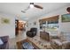 Bright living room with tile floors, a ceiling fan, and view to the kitchen dining area at 621 Tarpon Way, Punta Gorda, FL 33950