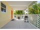 Covered porch featuring a grill, outdoor seating and lattice trim for privacy at 621 Tarpon Way, Punta Gorda, FL 33950