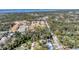 Aerial shot of a charming community with orange-tiled roofs, surrounded by mature trees and waterways at 681 Olive St, Englewood, FL 34223