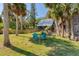 Tranquil backyard featuring blue chairs and a charming wooden home at 681 Olive St, Englewood, FL 34223