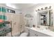 Bright bathroom featuring a shower-tub combo, a white vanity, and decorative coastal accents at 681 Olive St, Englewood, FL 34223