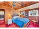 Bedroom with vaulted wood ceilings with fan and sliding glass doors to a private deck at 681 Olive St, Englewood, FL 34223