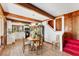 Cozy dining area with wood beams and a view into the well lit kitchen at 681 Olive St, Englewood, FL 34223