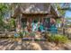 Inviting front porch with blue chairs, plants, and decorative accents creating a cozy entrance at 681 Olive St, Englewood, FL 34223