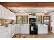 Bright kitchen featuring white cabinets, wood countertops, and stainless steel appliances at 681 Olive St, Englewood, FL 34223