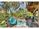 Inviting outdoor deck with comfortable seating, a dining area, and views of lush tropical landscaping at 681 Olive St, Englewood, FL 34223