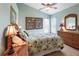 Bright bedroom with floral bedding, stylish lamps, and a dresser at 70 Sportsman Rd, Rotonda West, FL 33947