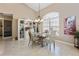 Dining room features a glass table, four chairs, and a built-in display cabinet at 70 Sportsman Rd, Rotonda West, FL 33947