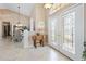 Inviting foyer with glass front doors and tile flooring offering a view into the dining room at 70 Sportsman Rd, Rotonda West, FL 33947