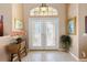 Inviting foyer featuring double front doors with decorative glass and tile flooring at 70 Sportsman Rd, Rotonda West, FL 33947