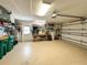 Spacious garage with storage, tool bench, garage door opener, and access to the outside at 70 Sportsman Rd, Rotonda West, FL 33947