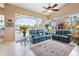 Bright living room featuring a high ceiling, ceiling fan, and large sliding glass doors to the pool at 70 Sportsman Rd, Rotonda West, FL 33947