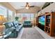 Spacious living room showcasing a decorative rug, ceiling fan, and built-in entertainment center at 70 Sportsman Rd, Rotonda West, FL 33947