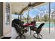 Covered patio featuring a table with seating, ceiling fan, a grill, and views of the pool area at 70 Sportsman Rd, Rotonda West, FL 33947