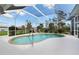 Screened-in pool area featuring a kidney-shaped pool and a partially covered lanai with seating at 70 Sportsman Rd, Rotonda West, FL 33947