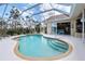 Relax in this large enclosed pool area with access to the home and the surrounding yard at 70 Sportsman Rd, Rotonda West, FL 33947