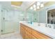 Bright bathroom featuring double sinks, spacious glass enclosed shower and large mirror at 7482 Palm Island Dr # 2522, Placida, FL 33946