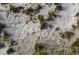 Aerial view of a sandy beach with shells spelling out 'WELCOME' amid scattered greenery at 7482 Palm Island Dr # 2522, Placida, FL 33946