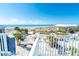 Scenic beach view with white sand and palm trees, seen from a high vantage point, with a pool in view at 7482 Palm Island Dr # 2522, Placida, FL 33946