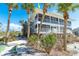 Island home on stilts with three stories and a large screened porch surrounded by Palm Trees at 7482 Palm Island Dr # 2522, Placida, FL 33946