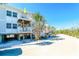 Beach house elevated on stilts features a covered porch and stairs, perfect for coastal living at 7482 Palm Island Dr # 2522, Placida, FL 33946