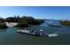 Aerial shot of a ferry carrying cars across a waterway, surrounded by lush green trees at 7482 Palm Island Dr # 2522, Placida, FL 33946