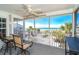 Relaxing screened-in porch with beautiful ocean views, a ceiling fan, and comfortable seating area at 7482 Palm Island Dr # 2522, Placida, FL 33946