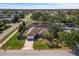 Aerial view of a corner-lot property with a well-maintained yard and mature landscaping in a quiet neighborhood at 803 Diane Cir, Englewood, FL 34223