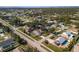 Aerial view of a neighborhood with mature trees and well-maintained homes near a wooded area at 803 Diane Cir, Englewood, FL 34223