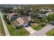 Aerial view of a single-Gathering home with a fenced yard and mature landscaping in a quiet neighborhood at 803 Diane Cir, Englewood, FL 34223