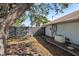 Enclosed backyard with gravel, partial fence, and a backup generator at 803 Diane Cir, Englewood, FL 34223