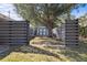 Backyard shed featuring horizontal privacy fence and established trees at 803 Diane Cir, Englewood, FL 34223