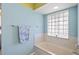 Light filled bathroom with large tub under window and pastel blue accents at 803 Diane Cir, Englewood, FL 34223