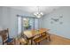 Sunny dining area with a large window and a wooden table with bench seating at 803 Diane Cir, Englewood, FL 34223