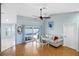 Bright living room with hardwood floors and sliding glass doors to the pool at 803 Diane Cir, Englewood, FL 34223