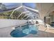 In-ground pool with caged pool area and outdoor furniture, ideal for outdoor living at 803 Diane Cir, Englewood, FL 34223