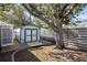 Exterior view of backyard shed with double doors and privacy fence at 803 Diane Cir, Englewood, FL 34223