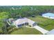 Beautiful aerial view of home with a large lot, screened pool, and mature trees in the backyard at 8205 Chico St, Port Charlotte, FL 33981