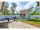 Landscaped backyard with a shed, grill, and patio area at 8205 Chico St, Port Charlotte, FL 33981