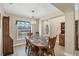 Bright dining room with a decorative chandelier, wainscoting, and elegant furnishings at 8205 Chico St, Port Charlotte, FL 33981