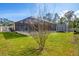 Backyard view of screened-in pool, storage shed, and well-maintained lawn under blue skies at 8205 Chico St, Port Charlotte, FL 33981