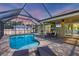 A beautiful pool with a screened enclosure, with an outdoor dining area and lots of space for lounging at 8205 Chico St, Port Charlotte, FL 33981